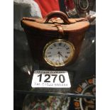 An unusual clock in the shape of a Victorian top hat box.