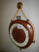 A vintage Kienzle wall clock with key.