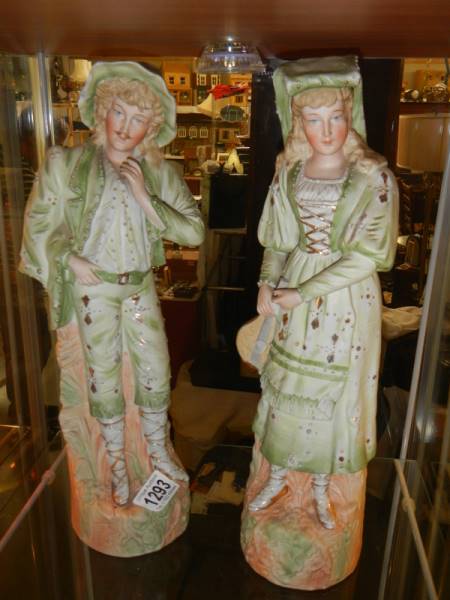 A pair of tall mid 20th century bisque porcelain figures in good condition.