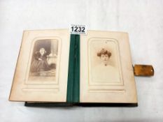 A Victorian photo album with mainly portraits