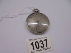 A silver pocket watch in working order.