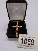 A superb quality yellow metal jewelled cross pendant on chain,