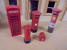 A doll house red phone box, three red pillar boxes and a red letter box.