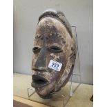 A Carved wooden African tribal mask.