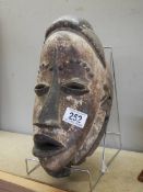 A Carved wooden African tribal mask.