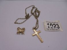 A 9ct gold cross on a plated chain and a cat charm.
