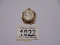 A shell cameo brooch in a tested 9ct gold mount.