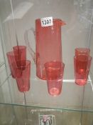 A cranberry glass lemonade set comprising jug and six tumblers.