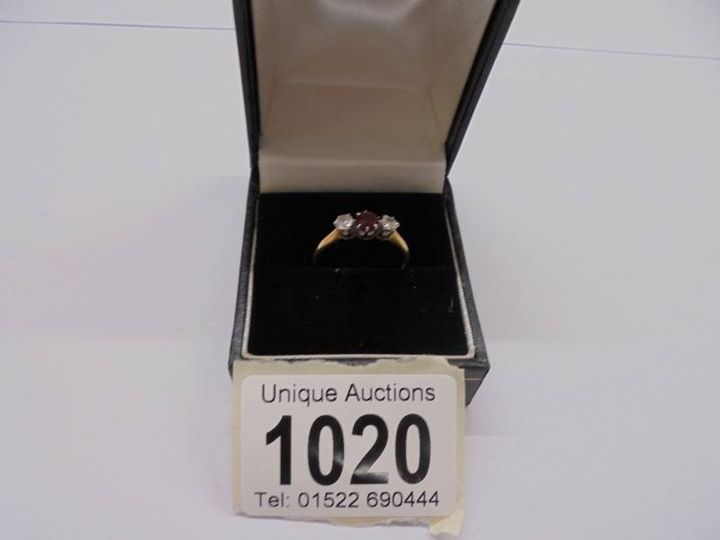 An 18ct gold set ruby and two diamonds, size M half, 1.8 grams.