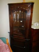 An oak glazed corner cabinet. COLLECT ONLY.