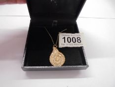 A yellow gold and diamond pendant, 6.9 grams.