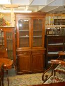 A mahogany two door glazed top book case, COLLECT ONLY.