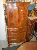 A mahogany two door cupboard on drawer base, COLLECT ONLY.