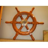 A ship/boat wheel with brass hub.