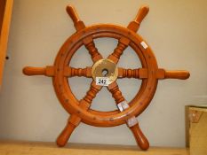 A ship/boat wheel with brass hub.