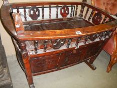An early Victorian carved rocking cradle. COLLECT ONLY.