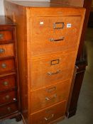 A four drawer wooden filing cabinet. COLLECT ONLY.