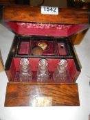 A fully fitted travelling jewellery box with three scent bottles,