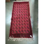 An old red wool rug, 61cm x 140cm COLLECT ONLY