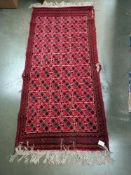 An old red wool rug, 61cm x 140cm COLLECT ONLY