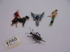Three sparkly brooches being lady walking a dog, parrot and pheonix together with a grasshopper pin.