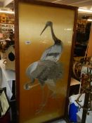 An oak framed and glazed embroidered panel featuring storks, COLLECT ONLY.