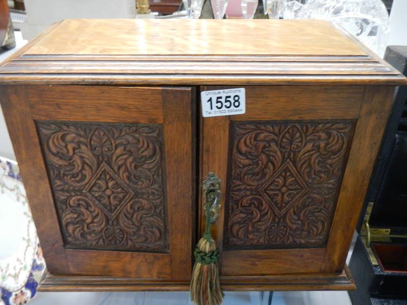 A smokers cabinet with carved doors, COLLECT ONLY.