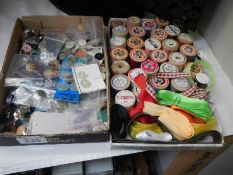 Two trays of vintage sewing items including wooden cotton reels etc.,