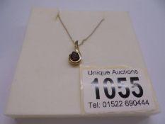 A 9ct gold pendant set red stone, marked 375. 1.5 grams.