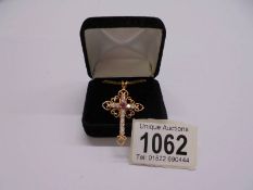 A superb quality yellow metal jewelled cross pendant on chain,