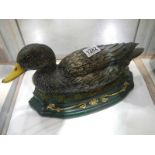 An old cast iron door stop in the shape of a duck.