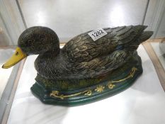 An old cast iron door stop in the shape of a duck.