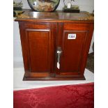 A mahogany smokers cabinet complete with tobacco jar and key. COLLECT ONLY.