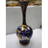 A blue and gold floral decorated vase.