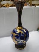 A blue and gold floral decorated vase.