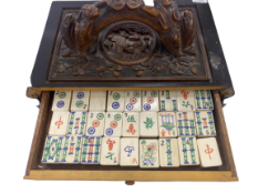 An early 20th century Mahjong set in carved wooden box (missing front) with bone and bamboo tiles.