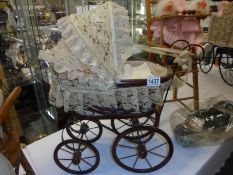 A Victorian style dolls pram with doll, COLLECT ONLY.