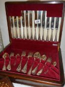 A mahogany cased canteen of cutlery.