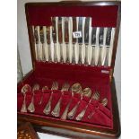 A mahogany cased canteen of cutlery.