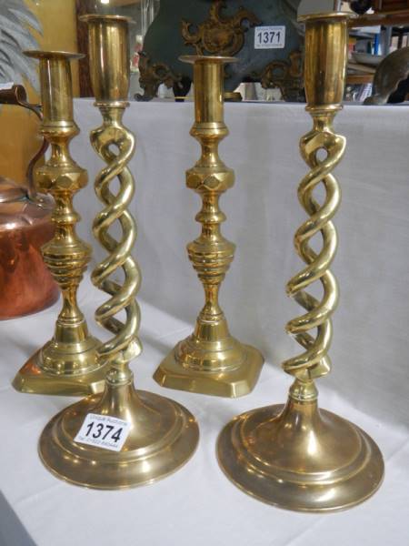 A pair of Victorian brass candlesticks and a pair of brass barley twist candlesticks.