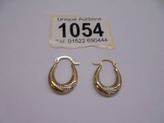 A pair of 9ct gold earrings, 0.6 grams.