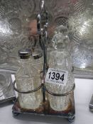 A Silver plate and glass condiment set.