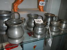 Seven antique pewter measures, all stamped.