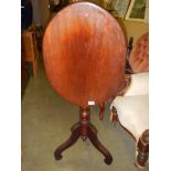 An oval mahogany tip top table on tripod base. COLLECT ONLY.