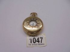 A gold plated half hunter pocket watch, Elgin USA, in working order.