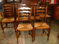 A set of six oak ladder back chairs. COLLECT ONLY.