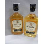 Two half bottles of Special Reserve whisky.