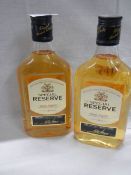 Two half bottles of Special Reserve whisky.