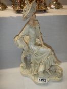 A seated figure of a lady.