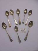 Eight silver teaspoons, approximately 4 ounces. (124 grams).